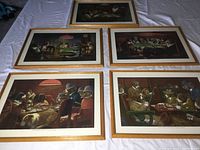 Five framed CM Coolidge Dogs Playing Poker prints laid on surface with titles visible