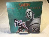 Front cover of Queen News of the World LP dust jacket showing album art of robot holding band members.