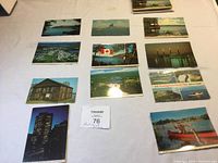 Full view of multiple vintage Canadian postcards laid out on a white surface, showing natural and urban scenes