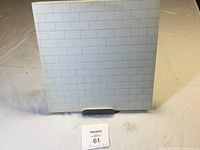 Front white brick wall design on vinyl album jacket.