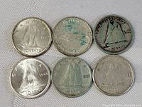 Six Canadian dimes from 1943 to 1966, showing the Bluenose schooner on reverse with mixed condition and tarnishing.