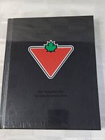 Front cover of sealed book with Canadian Tire logo and partial title visible.
