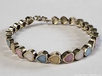 Close-up of the sterling silver bracelet with heart-shaped multi-colored stones showing clasp and stone details