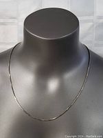 Full view of the sterling silver box chain necklace displayed on a mannequin bust, showing the full 22 inch length and classic style.