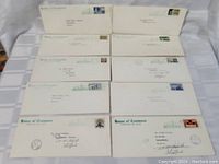 Top view of multiple First Day Covers envelopes from House of Commons Canada with various Canadian stamps and postmarks.