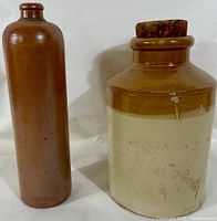 Photo of the two stoneware items showing the full bottle and crock side by side on a white background.