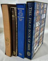 Four hardcover Folio Society books standing upright, showing spines: The Folio Book of Days, The Mill on the Floss, My Life, The Story of San Michele.