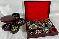 Overview of the lot showing the two wooden organizer boxes containing mixed estate jewelry items such as bracelets, necklaces, and brooches.