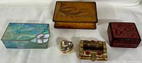Overall grouping of six trinket and ring boxes showing variety in materials and design.