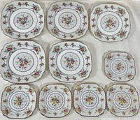 Top view showing all 10 plates in varying sizes with vintage Royal Albert Petit Point floral pattern and gold trim.