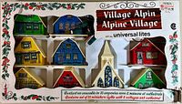 Boxed set of 10 miniature Alpine Village styled electrified Christmas lights by Universal Lites, showing original packaging front with holiday decorated border and product label in French and English.