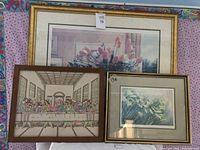 Three framed pictures arranged side by side showing the floral print, Last Supper tapestry, and reeds print