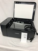 Canon multifunction printer with copier and scanner features, open document feeder lid, power cord included, showing control panel.