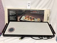 Electric Rival warming tray with original box showing product image and multilingual description.