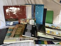 Organized display of scrapbooking albums, assorted paper packs and sticker sheets