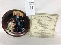 Collector plate depicting Norman Rockwell's 'Tender Loving Care' painting showing an elderly man interacting with children, with gold rim. Accompanied by Certificate of Authenticity placed next to the plate.