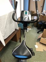 Front view of the Pro Form exercise bike showing handlebars, digital display and padded seat.