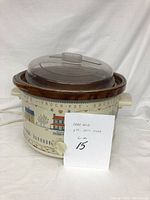 Rival crock pot with clear lid and removable ceramic pot, showing decorative printed outer shell.