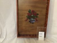 Wooden tray with festive painted bell and holly design