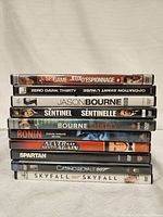 Photo showing the stacked DVD cases of 10 different spy and action movies.
