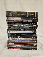 15 sci-fi/fantasy DVDs stacked vertically showing titles and cases.