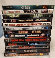 Photo showing the spines of the stacked DVDs with titles clearly visible.
