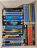 Box with assorted PC game cases arranged side by side showing titles