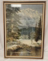 Front view of the framed landscape painting showing a winter scene with snow, river, pine trees, a bird in flight, and a mountain in the background