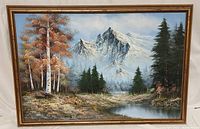 Frontal photo of framed scenic landscape painting depicting forest, stream, and mountain.