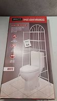 Photo of the product box showing the white metal 3 tier bathroom space saver organizer placed over a toilet illustration with product features and dimensions.