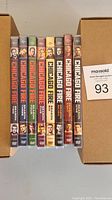 Photo of DVD box sets for Chicago Fire seasons 2 to 9 arranged vertically showing spine artwork with character faces and season numbers.
