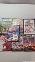 Top-down image showing all seven DVD cases. Titles related to Looney Tunes and Duck Dodgers are visible.