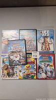 Nine DVD cases showing various titles from Madagascar, The Penguins of Madagascar, and Ice Age.