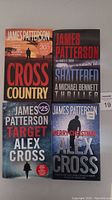 Photo showing four hardcover James Patterson books titled Cross Country, Shattered, Target Alex Cross, and Merry Christmas Alex Cross.