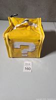 Front view of yellow square bag with white question mark symbol from Mario Brothers series.
