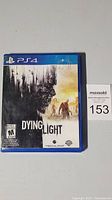 Front cover of Dying Light PS4 game showing original artwork and rating.