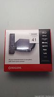 Photo of sealed Rogers Entertainment Box 2 packaging, showing device and remote, listing streaming services supported.