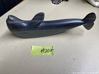 Soapstone carving of a marine animal from side view showing form and finish.