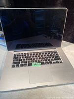 Open laptop showing keyboard, trackpad, and blank display