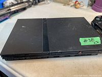 Sony PlayStation 2 console showing the top surface with PS2 logo and controller connection ports