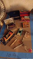 Overview of vintage safety razor lot including razors, boxes of blades, and velvet lined cases