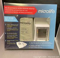 Front view of original sealed blue box shows model and features including 2-user memories, one-size cuff for arms 8.7" to 16.5", latex free cuff, and clinical accuracy statements.