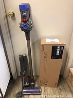 Assembled vacuum with wand, motorbar head, docking station and original cardboard box