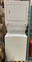 Full front view of white stacked washer and dryer
