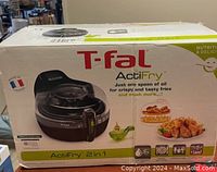 Box of T-Fal ActiFry 2in1 showing brand, model, some features, and food images