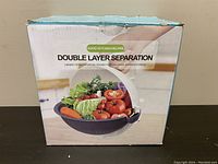 Front of retail box showing double layer separation wet basket vegetable cutter with produce inside on front illustration.