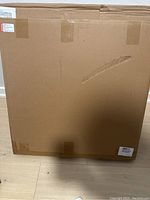 Sealed large cardboard box containing the photo light box kit