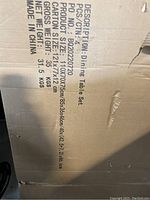 Photo of product info and carton dimensions from the box, showing model number B20220720 and dimensions 110x70x75 cm (table) with net weight 31.5 kgs.