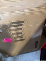 Full view of cardboard packaging showing crate line drawing