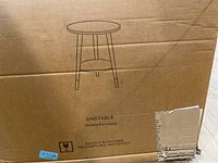 Cardboard box with drawing and name 'End Table, Urraca Furniture'